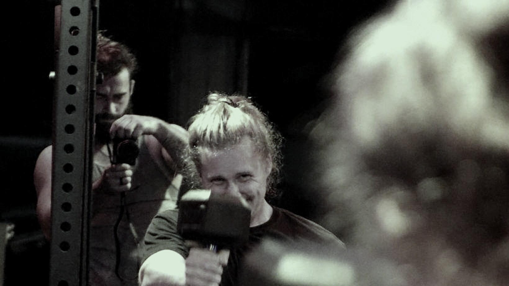 Two members training side by side and encouraging each other in the gym
